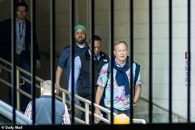 Ken Paxton confidently exits hotel in Hawaiian shirt hours before primary win.