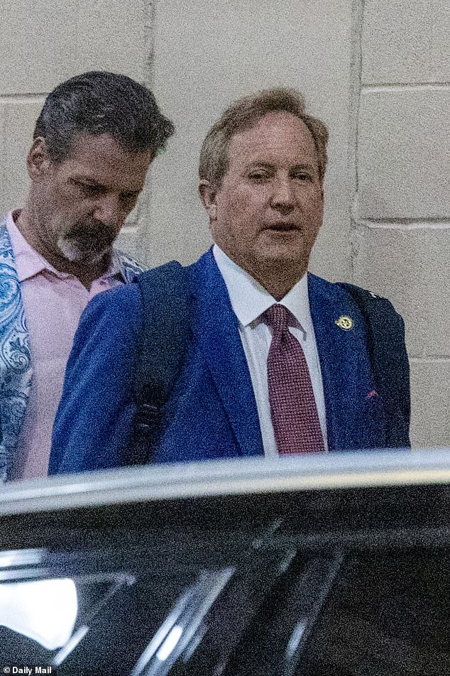 Ken Paxton confidently exits hotel in Hawaiian shirt hours before primary win.