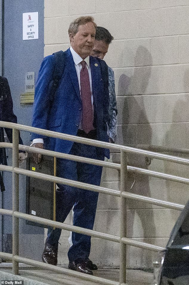 Ken Paxton confidently exits hotel in Hawaiian shirt hours before primary win.